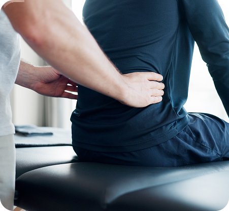 Chiropractor examining a patient's lower back
