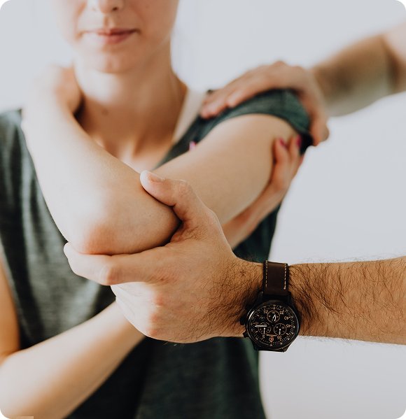 Chiropractor treating a patient’s elbow