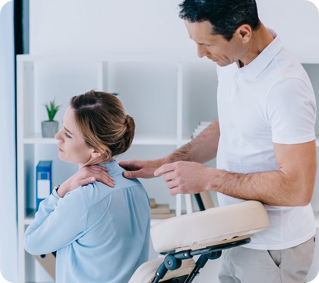 Chiropractor examining a patient’s shoulder