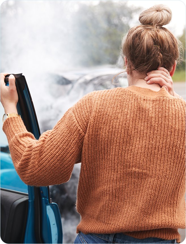 Woman holding her neck after a car accident