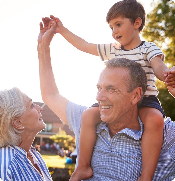 A grandfather and grandchild playing outdoors